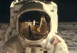 Armstrong seen in the reflection on Aldrin's visor
