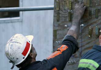 A miner moves his brass check tag at the of a shift