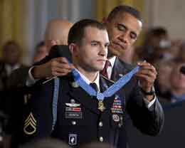 Guita receives the medal. White House: Chuck Kennedy