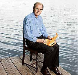 Nicholas Negroponte with a laptop