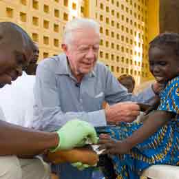 Jimmy Carter comforts a little girl